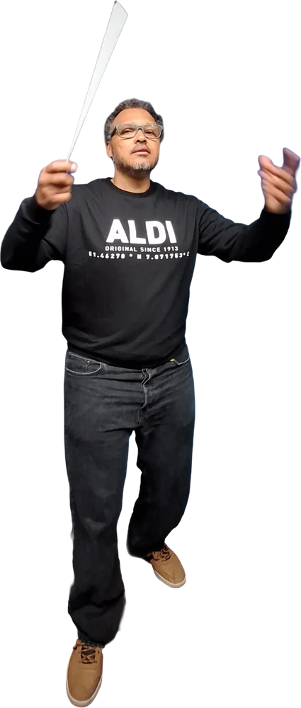 Gudu Lopes conducting mid-gesture, baton raised